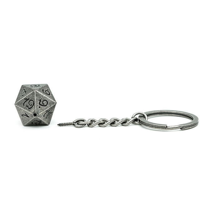 Dice-shaped keychain with chain on a white background