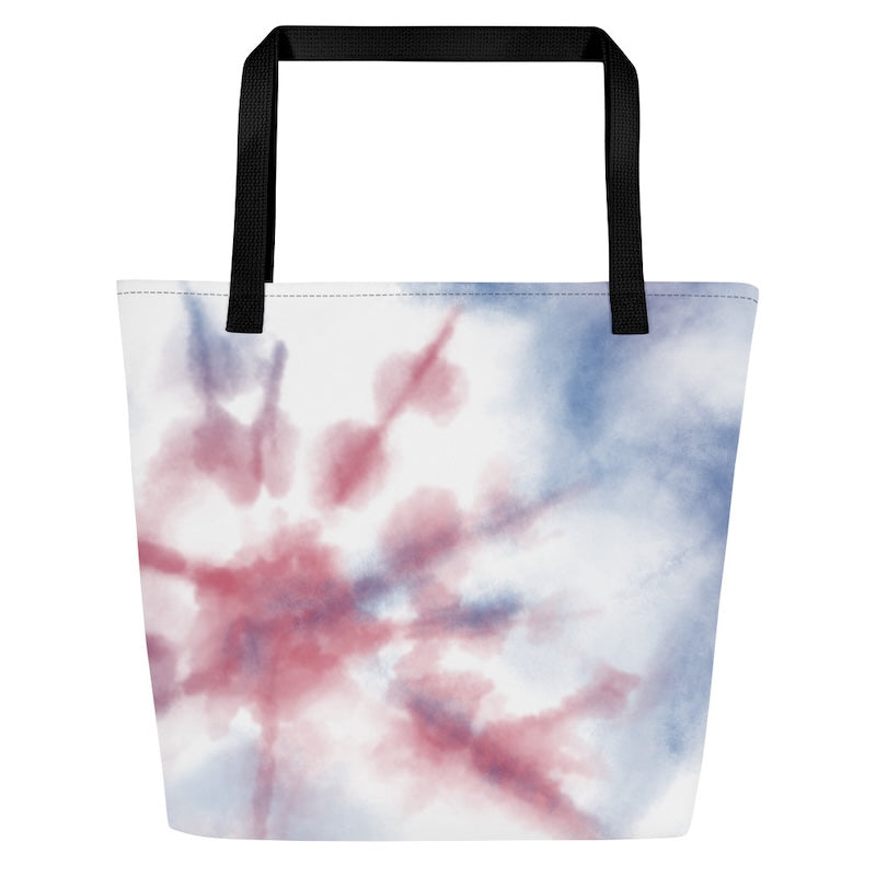 Tote bag with tie-dye design and black handles on a white background