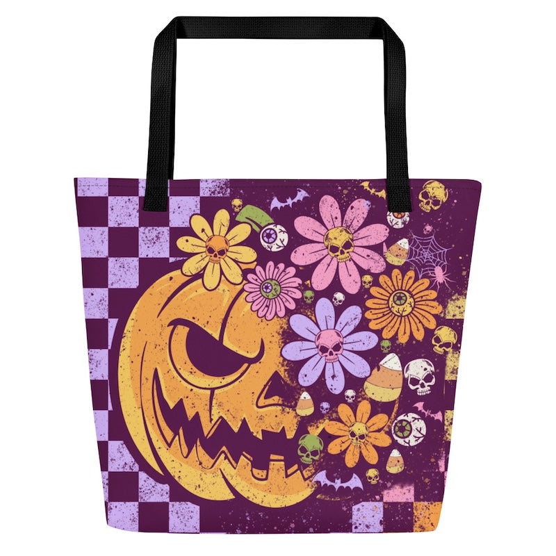 Tote bag with Halloween-themed design featuring a pumpkin face and flowers on a purple background.