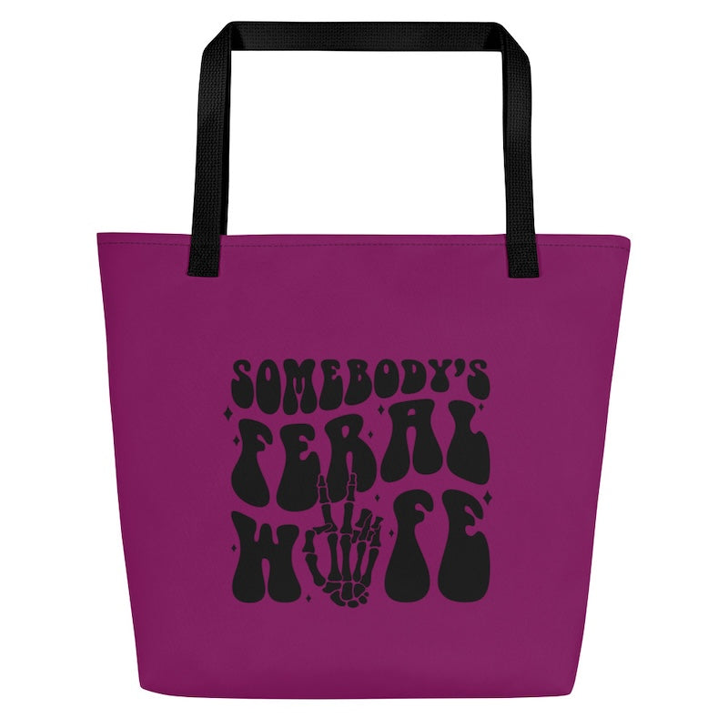 Purple tote bag with black text and skeleton hand design on a white background