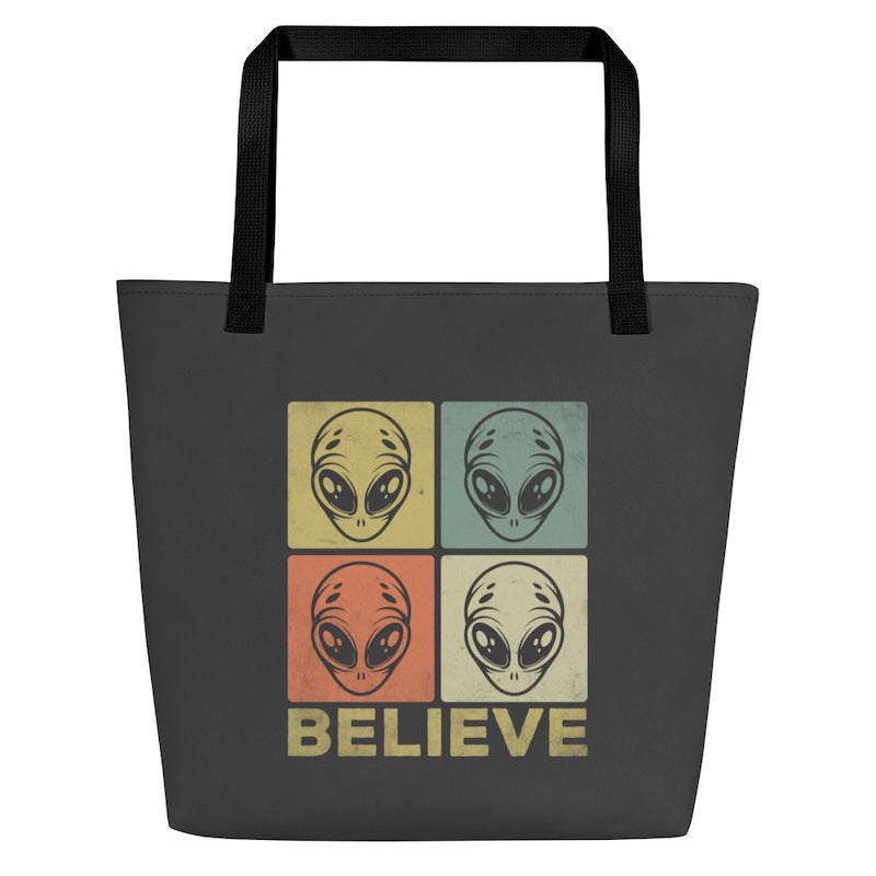 Tote bag with alien design and 'BELIEVE' text on a white background