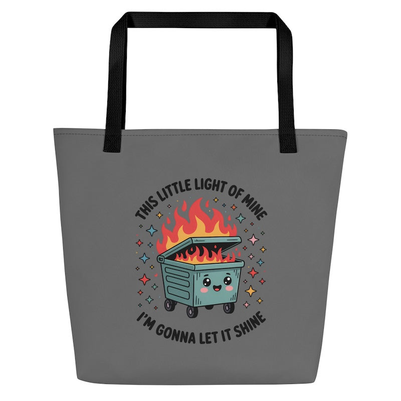 Gray tote bag with a cartoon dumpster and text design on a white background