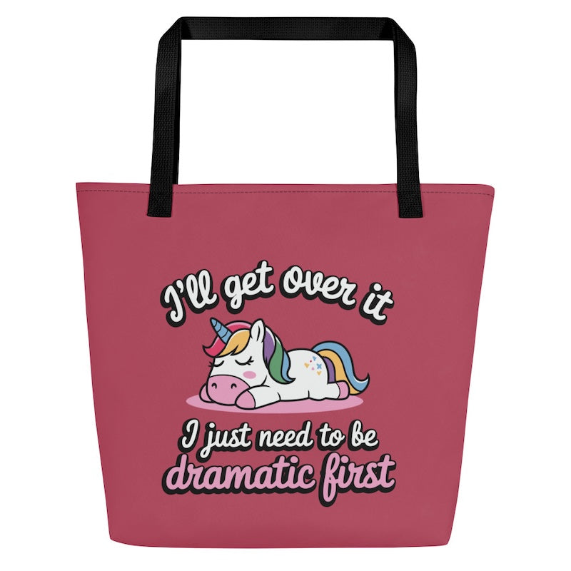 Pink tote bag with a unicorn graphic and humorous text on a white background