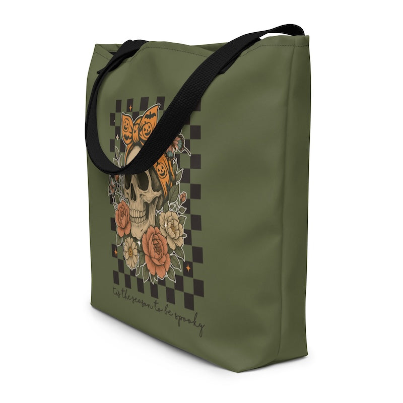 Green tote bag with skull and floral design on a white background