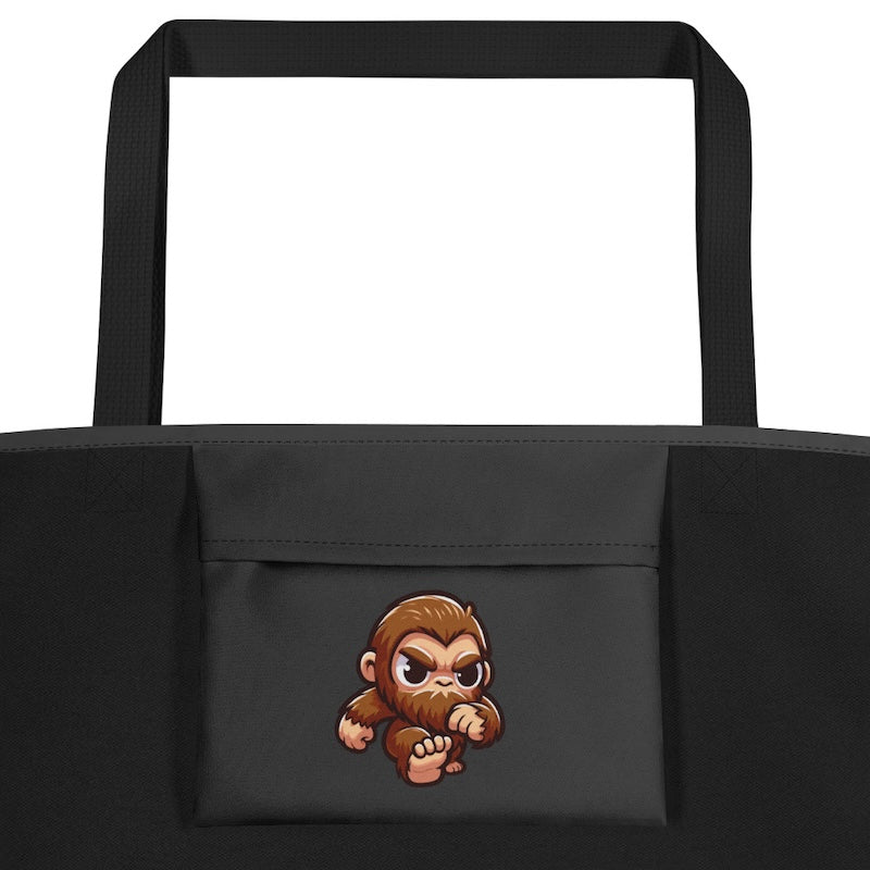 Black tote bag with a cartoon monkey design on a white background