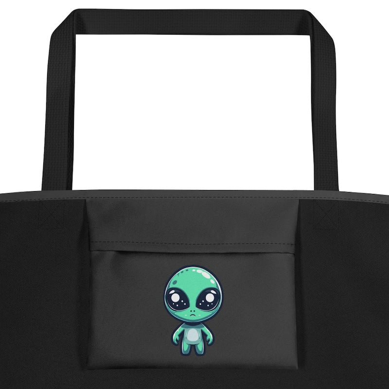 Black tote bag with a cute green alien design on a white background