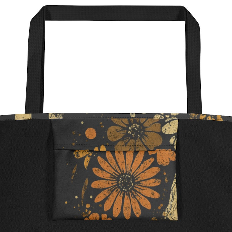 Black tote bag with orange floral patterns on a white background