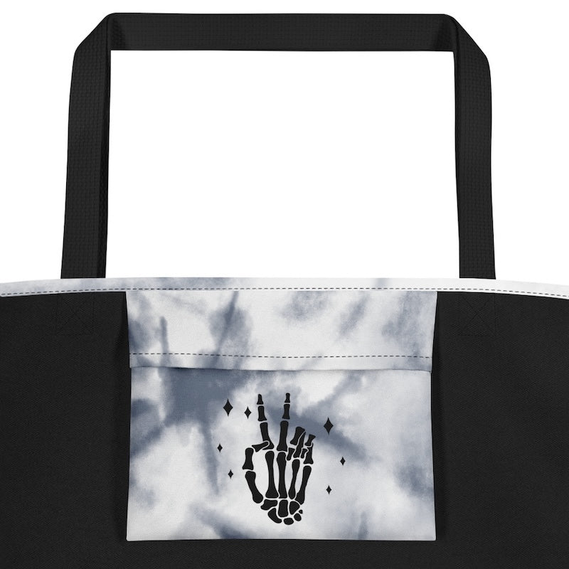 Tote bag with skeleton hand design on a white background