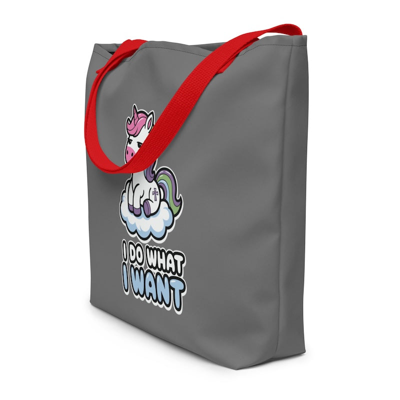 Gray tote bag with red handles featuring a unicorn graphic and text on a white background