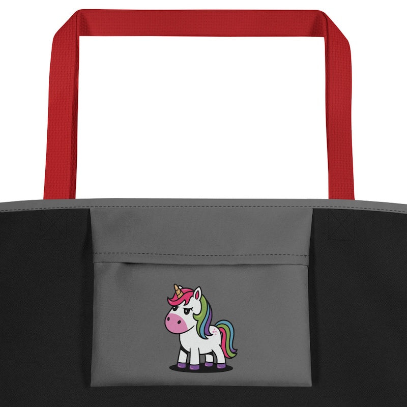 Gray tote bag with red handles featuring a cartoon unicorn on a white background