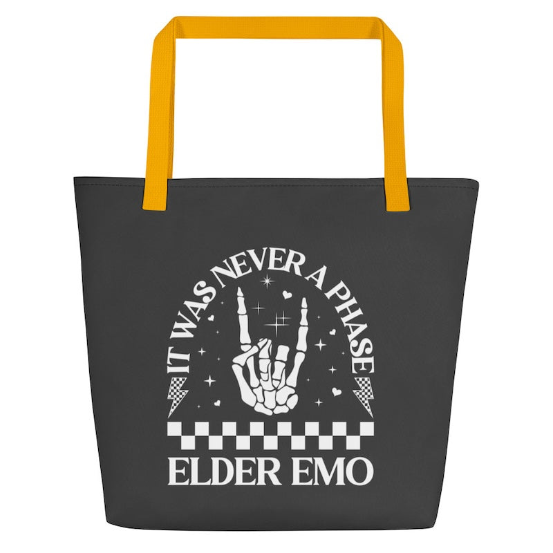Black tote bag with yellow handles featuring a hand gesture and text design.