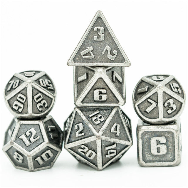 Set of metallic polyhedral dice on a white background