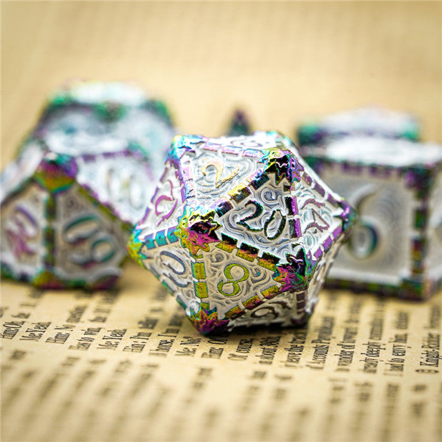 Decorative polyhedral dice with metallic sheen on a textured surface