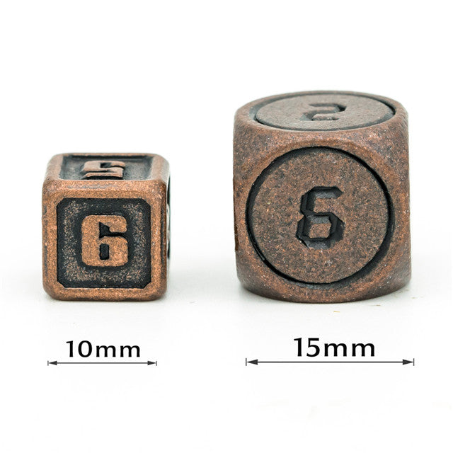 Two metal dice with numbers embossed, one square and one round, on a white background.