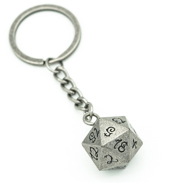 Metal keychain with a star-patterned die on a white background