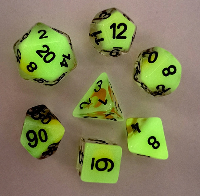 Set of green dice with black numbers on a beige background