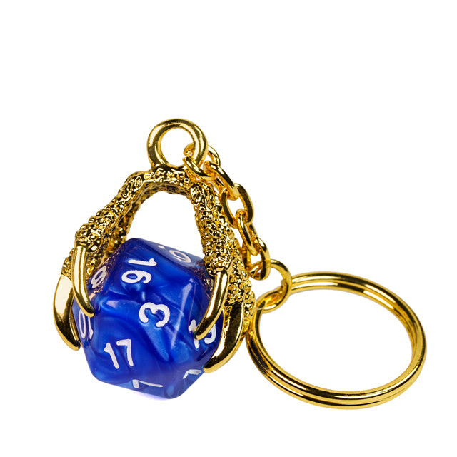 Blue die-shaped keychain with gold metalwork on a white background