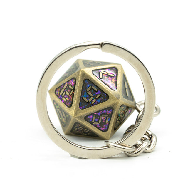 Metallic polyhedral dice keychain with a ring on a white background