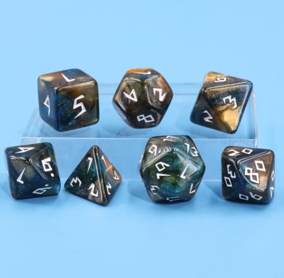 Set of polyhedral dice with black and metallic gold faces on a blue background
