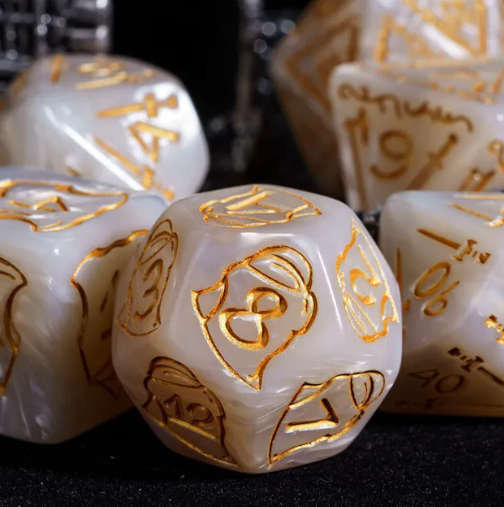 White dice with gold numbering on a dark background