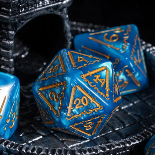 Blue polyhedral dice with gold numbers on a textured black surface