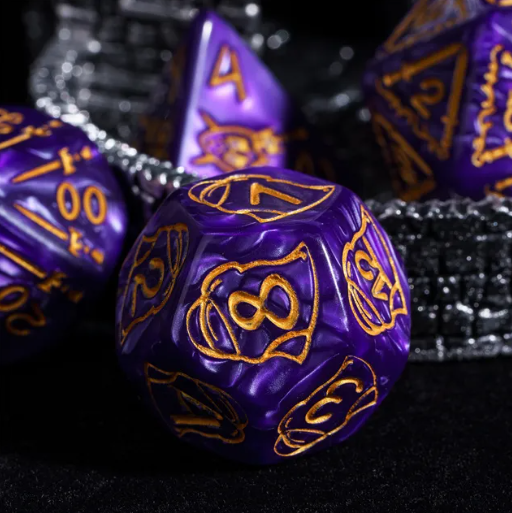 Purple polyhedral dice with gold numbering on a black background