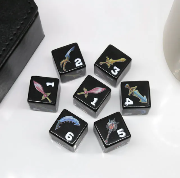 Black dice with sword and shield designs on a white surface