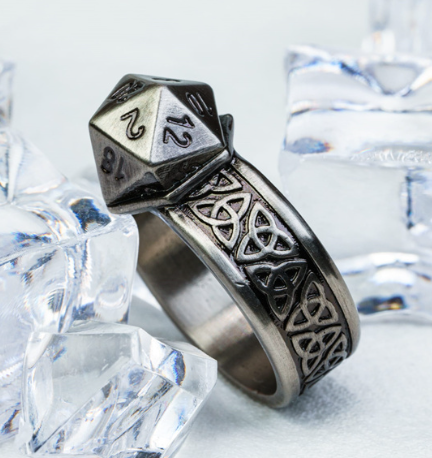 Metallic ring with star and triangle design on a white background