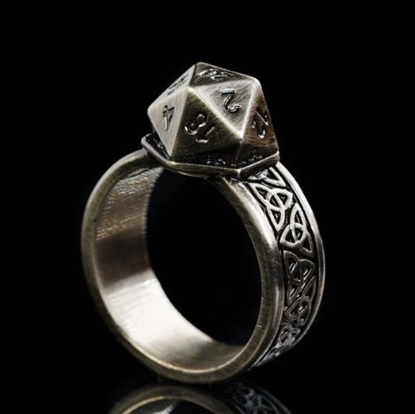 Silver ring with a d20 die on a black background