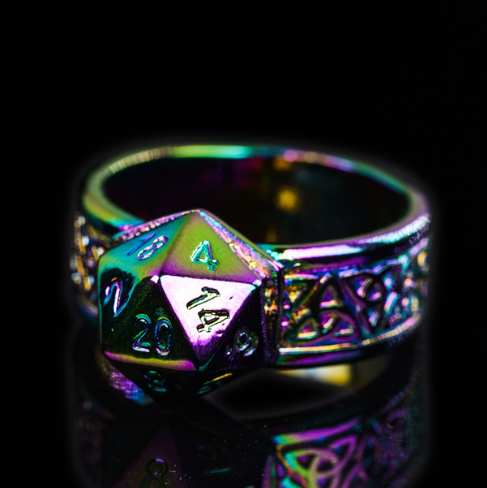Multicolored die-shaped ring with intricate design on a black background