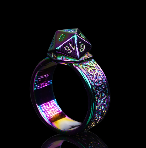 Multicolored ring with a dice-shaped top on a black background