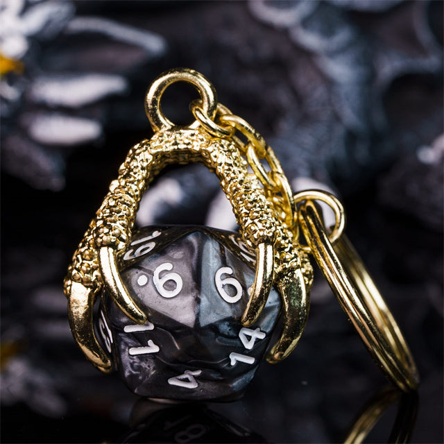 Gold pendant with a black die inside on a dark background