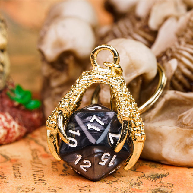 Gold pendant with a black die on a textured surface
