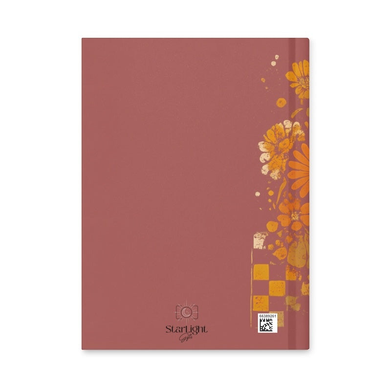 Red notebook with floral design on a white background