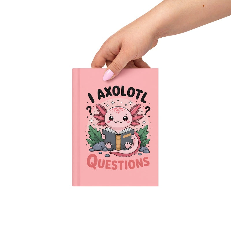Pink notebook with axolotl illustration and text, held by a hand on a white background