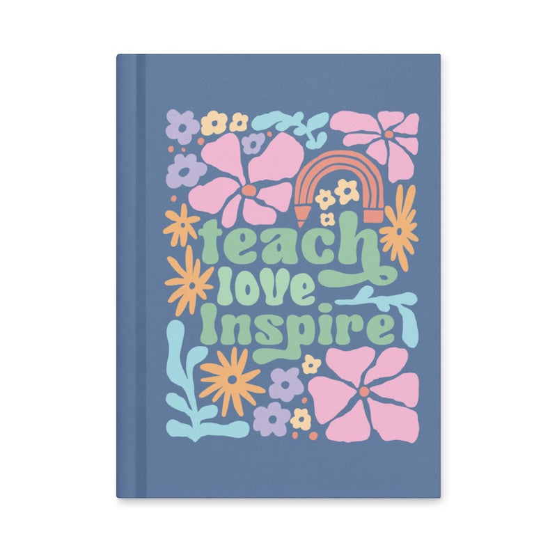 Notebook with colorful floral design and 'teach love inspire' text on a blue background