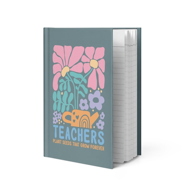 Notebook with floral design and 'Teachers Plant Seeds That Grow Forever' text on a white background