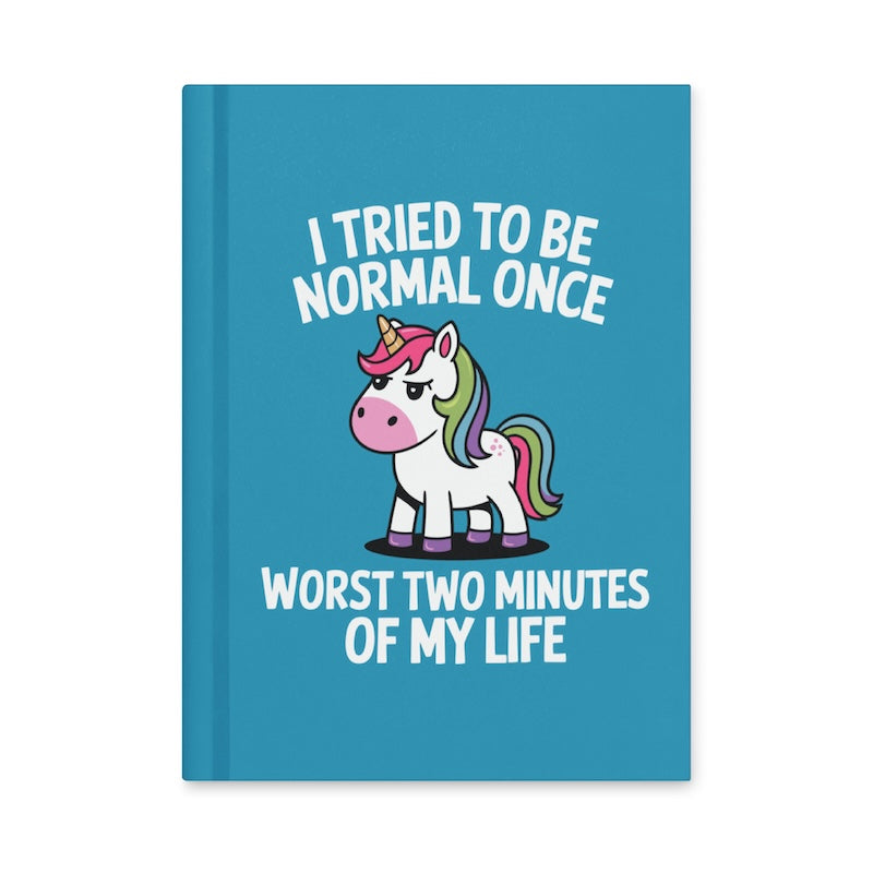 Blue notebook with a unicorn illustration and humorous text on a white background