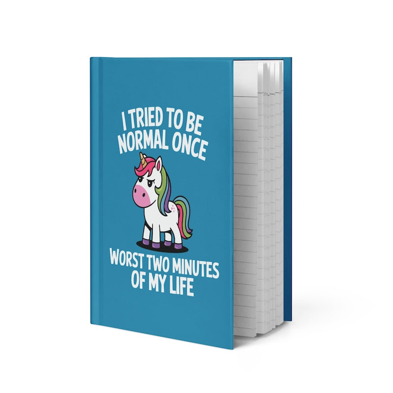 Blue notebook with a unicorn illustration and humorous text on a white background