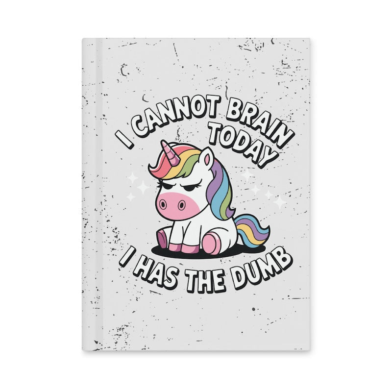 Notebook with a unicorn illustration and humorous text on a white background