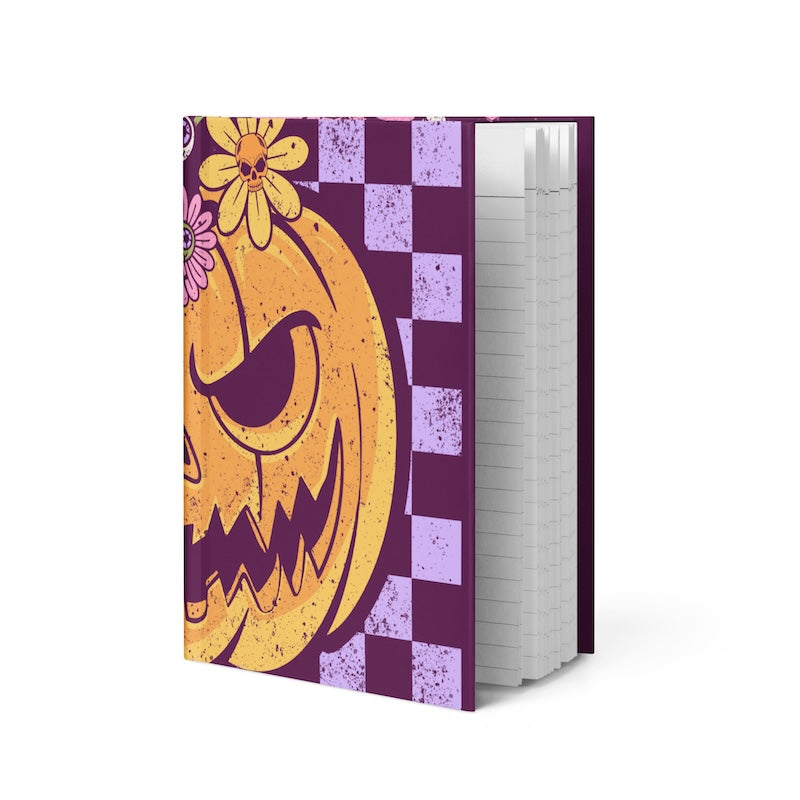 Notebook with a pumpkin design on a purple cover