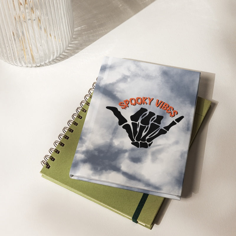 Notebook with 'Spooky Vibes' design on a white surface