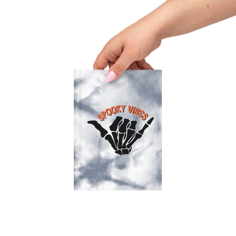 Hand holding a tie-dye product with 'Sticky Vibes' text and hand symbol.