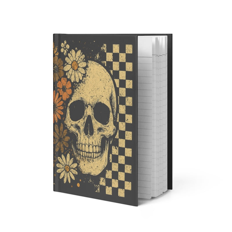 Notebook with a skull and floral design on a black background