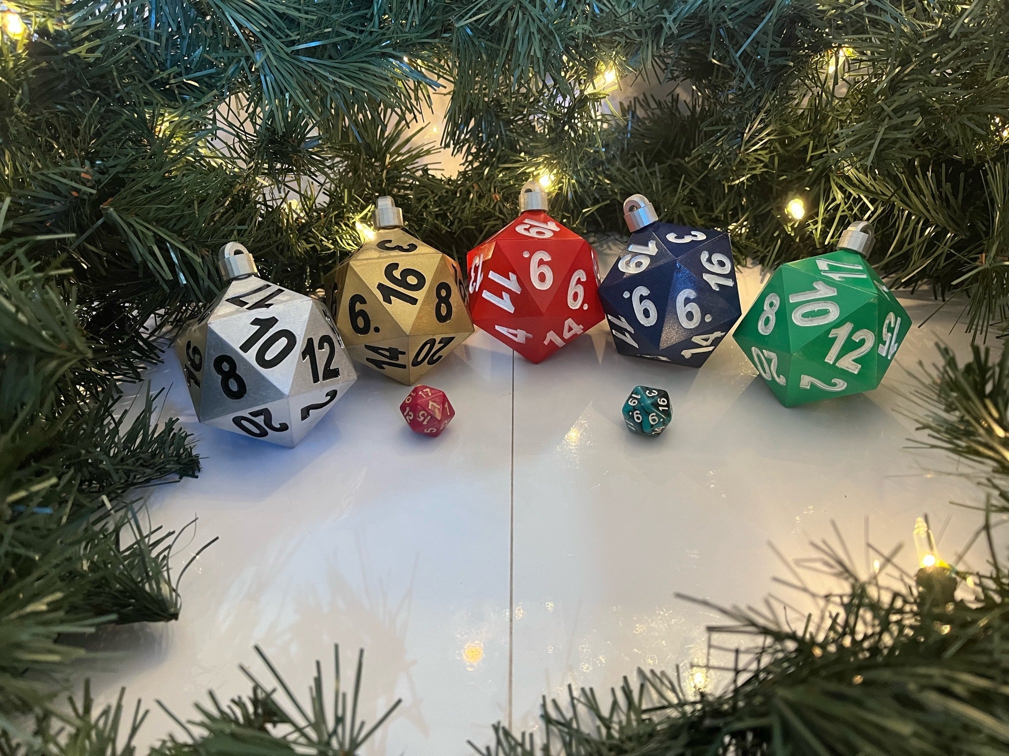 Colorful dice ornaments on a Christmas tree with lights.