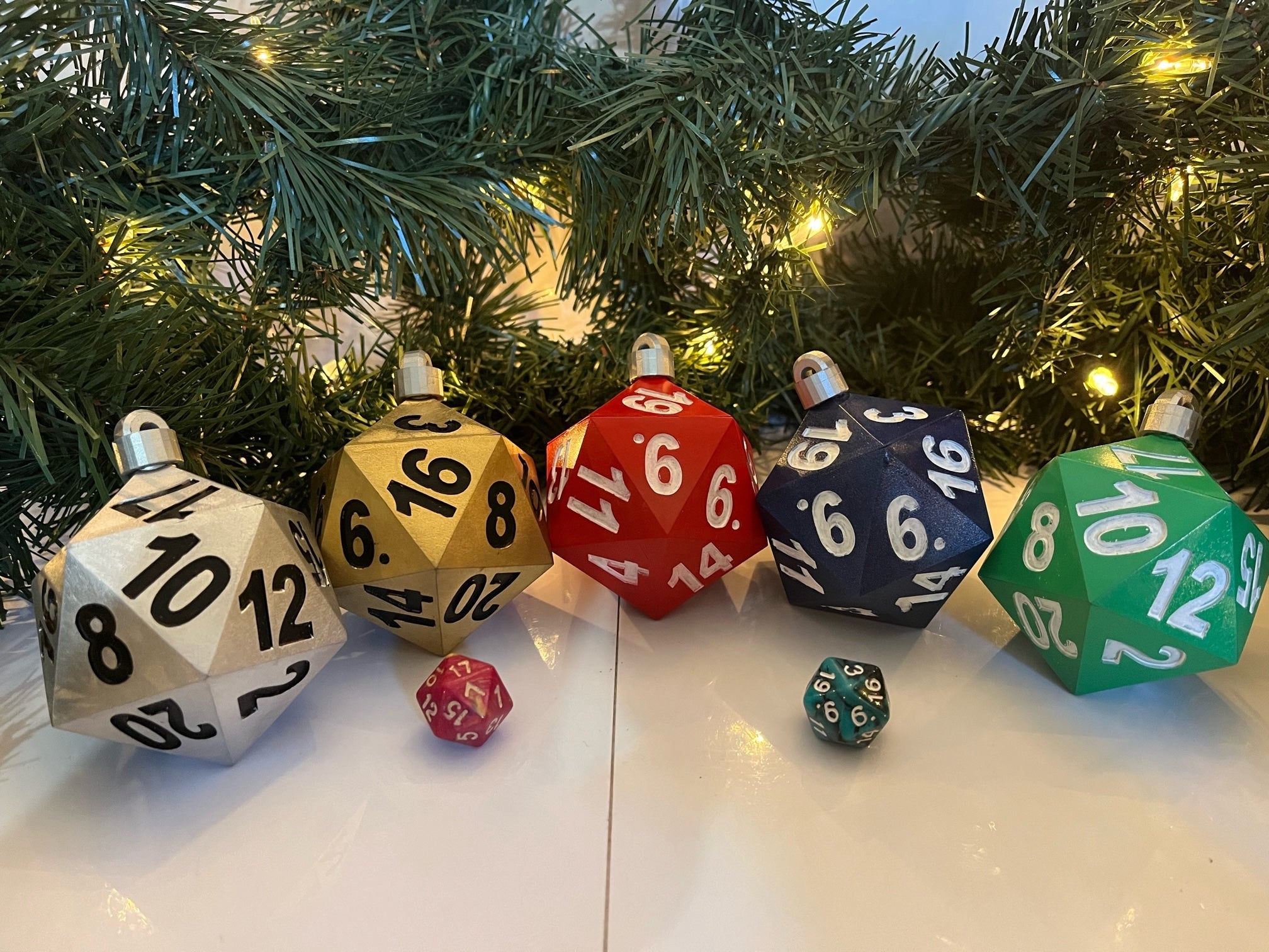 Colorful dice ornaments on a Christmas tree with lights.