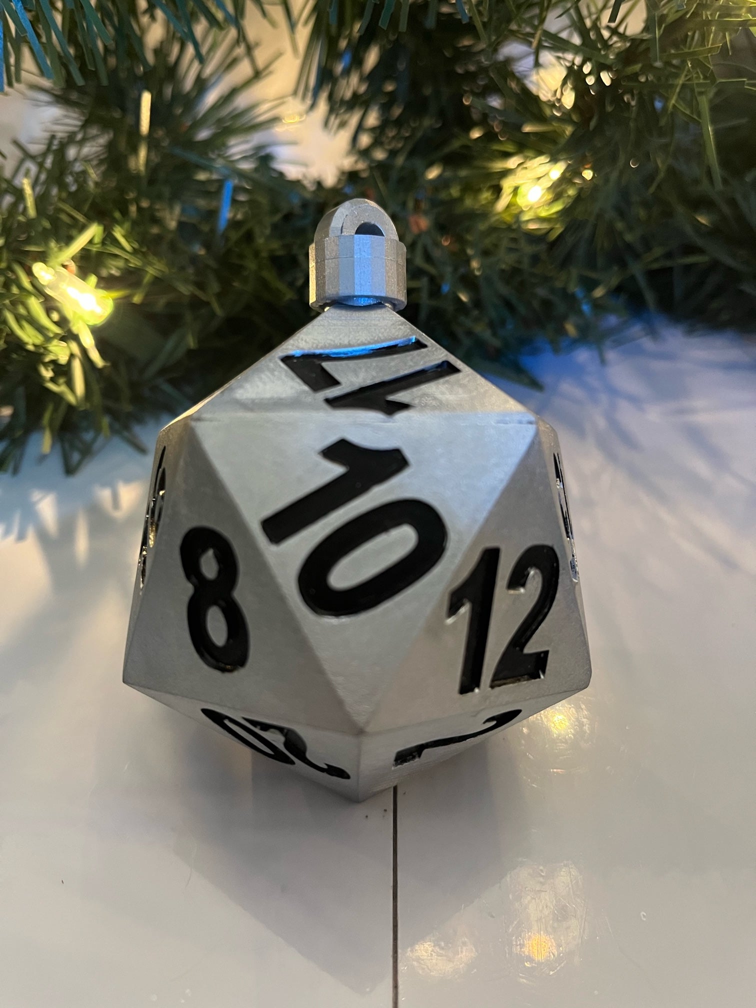 D20 dice ornament with numbers on a Christmas tree