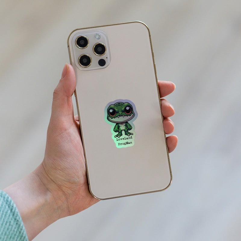 Phone case with a green character sticker on a plain background
