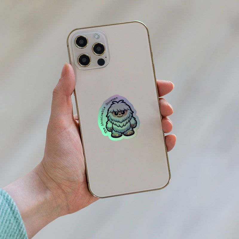 Phone case with a glowing creature design held by a hand