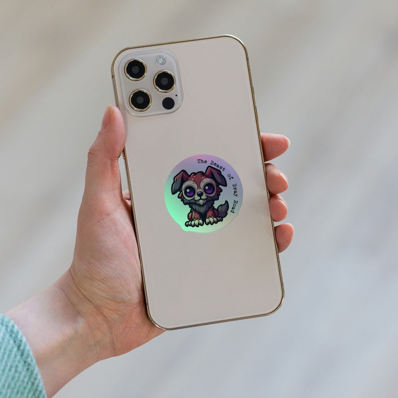 Phone case with a cartoon dog design held by a hand against a neutral background